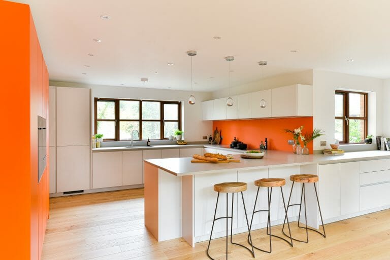 White Kitchen with Orange Accents