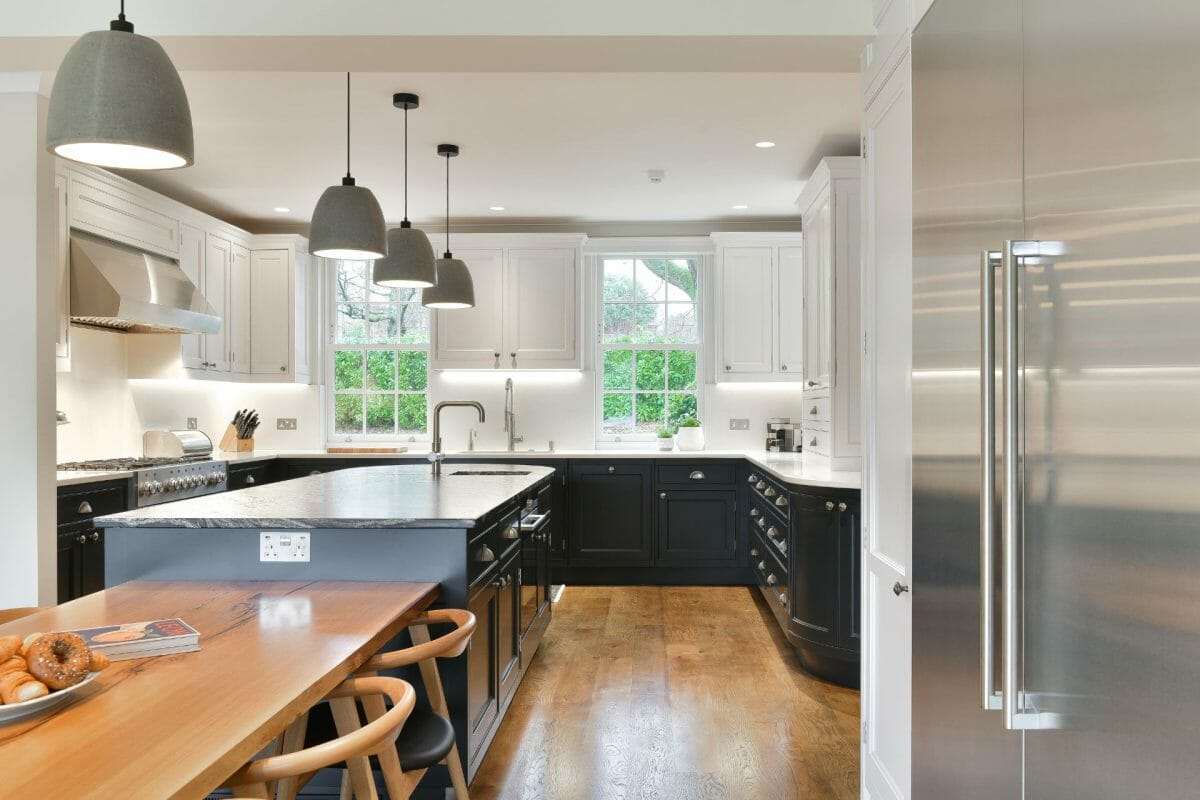 Dark Shaker Kitchen with fridge and island with connecting dining table