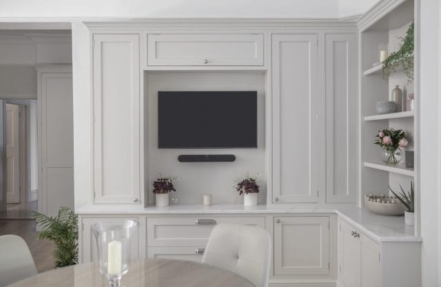 Bespoke painted shaker cabinetry with integrated TV unit and open display shelving, Ashley Jay Kitchens Horsham