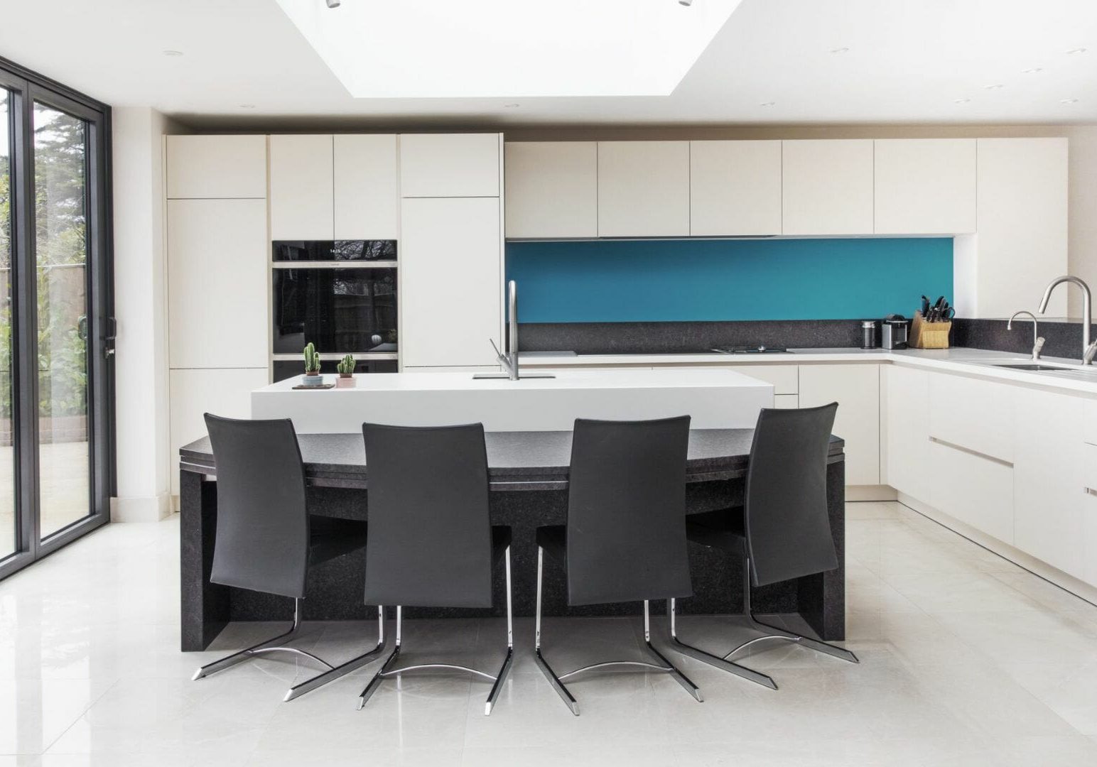 White Handleless Kitchen with Dinner table Island
